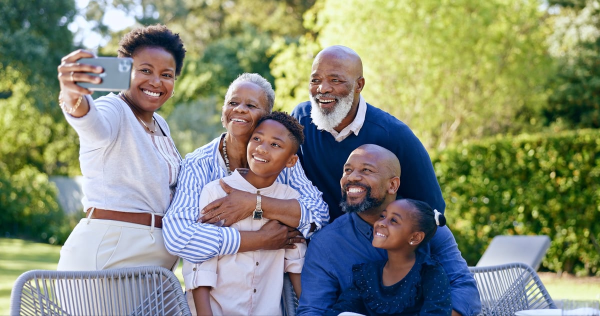 A multi-generational Black family smiling together during their Jamaican holiday