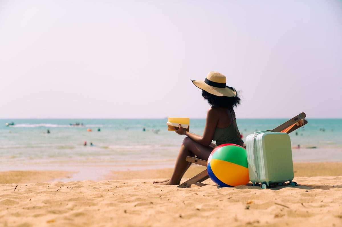 A relaxed Black woman enjoying the sun on a Jamaican beach