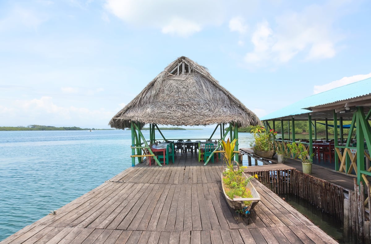 A thatched-roof bar built on stilts over the sea, like Floyd's Pelican Bar in St Elizabeth